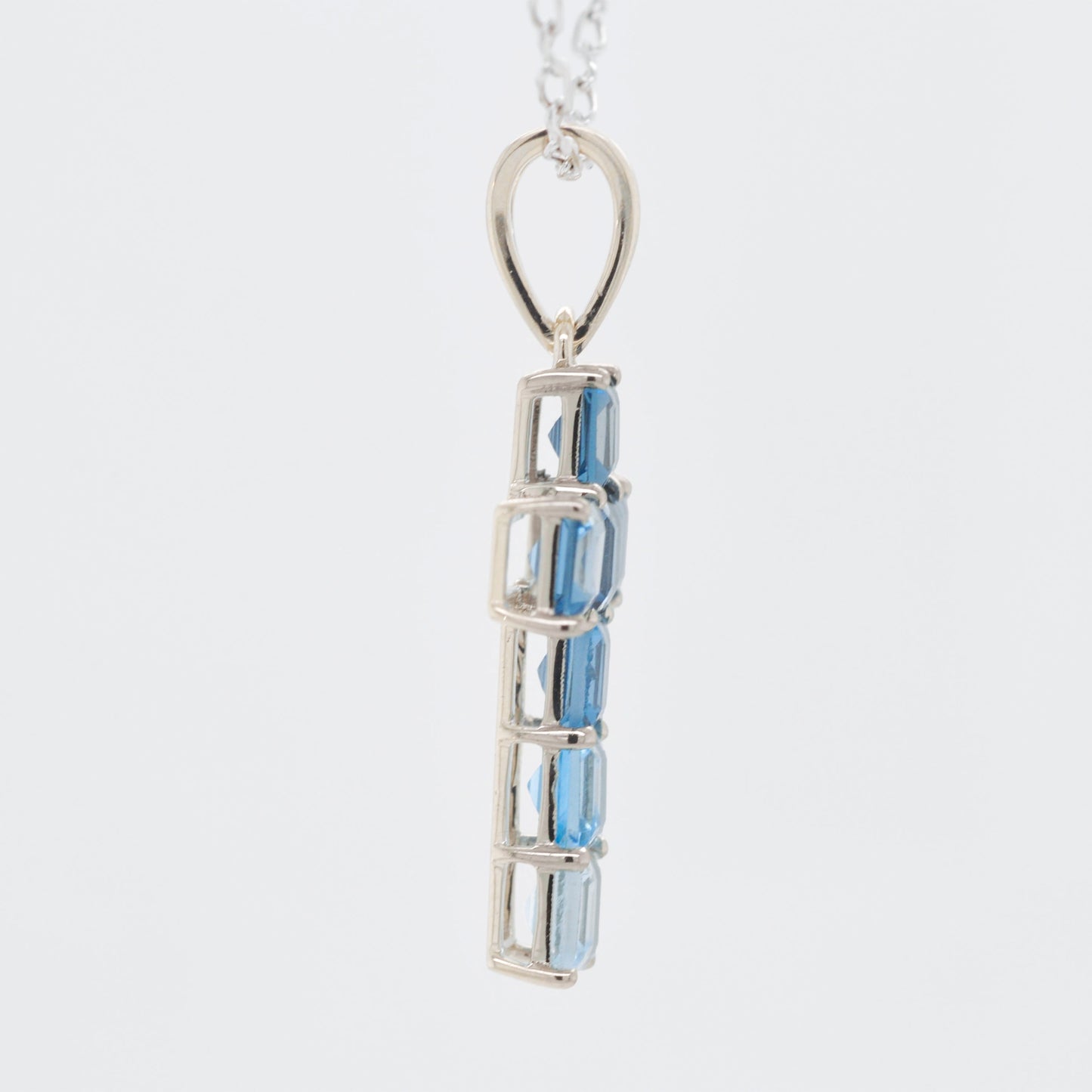 Linear Blue Topaz Cross Pendant