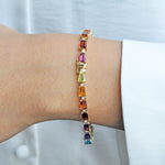 Close-up of the hinged multi-gem bracelet worn on a wrist, showcasing comfort and the secure closure function.