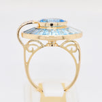 Fine jewelry rotating blue topaz and diamond spinner ring close-up