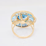 Fine jewelry rotating blue topaz and diamond spinner ring back shot.