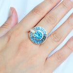 Elegant model wearing luxury rotating blue topaz gold ring