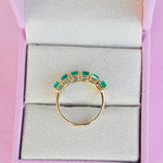 Top shot of the 14k Gold 6 emerald ring in jewelry box.