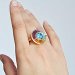 Blue topaz center spinner ring worn on hand luxury jewelry shot