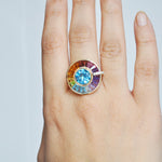 Close up model shot of yellow gold rotating halo gemstone ring
