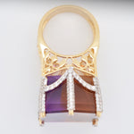 Clear view of the solid gold shank and the structural support holding the large carved ametrine.