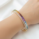 Model’s hand wearing the statement multicolor bracelet, illustrating its substantial width and vibrant color spectrum.