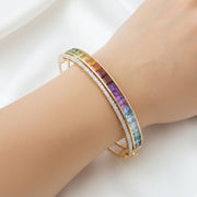Model’s hand wearing the statement multicolor bracelet, illustrating its substantial width and vibrant color spectrum.