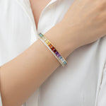 Lifestyle shot of a vibrant 14K yellow gold multi-gem bracelet