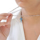Linear Blue Topaz Cross Pendant
