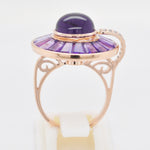 Circular amethyst cluster ring in a 14K rose gold setting, featuring a dome cabochon and baguette cuts.