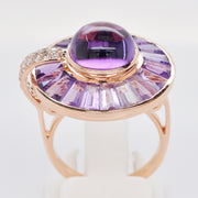 A tight shot showcasing the smooth cabochon texture and the geometric cuts of the surrounding amethyst stones.