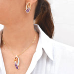 Elegant ametrine jewelry set with sickle-shaped pendant and earrings from Vaibhav Dhadda, showcasing purple and yellow tones in yellow gold