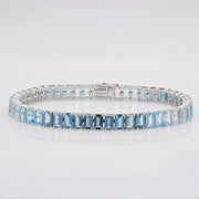 Detailed view of the emerald-style octagon cut blue topaz stones held in a four-prong setting.
