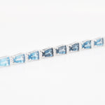 Side view of the 14K white gold bracelet highlighting the elegant height of the four-prong settings.