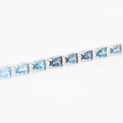 Side view of the 14K white gold bracelet highlighting the elegant height of the four-prong settings.