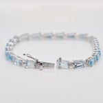 Close view showing how to operate the integrated closure on the blue topaz and diamond jewelry piece.