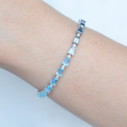 Lifestyle shot showcasing the bracelet's size and vibrant blue colors against a neutral background.