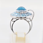 Perspectival shot illustrating how the upper gemstone cluster rotates independently on the white gold band.