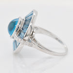 A tight close-up showcasing the smooth cabochon texture and the geometric cuts of the surrounding baguette gems.