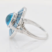 A tight close-up showcasing the smooth cabochon texture and the geometric cuts of the surrounding baguette gems.
