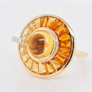 Macro detail of the channel setting holding tapered baguette citrines around a smooth central cabochon.