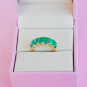 The 14K gold emerald ring in jewelry box.