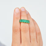 Lifestyle photograph of the emerald and gold cocktail ring.