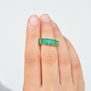 Lifestyle photograph of the emerald and gold cocktail ring.