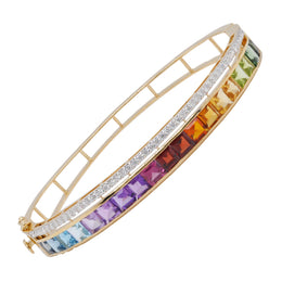 A diagonal three-quarter view of a 14K yellow gold bangle featuring a vibrant gradient of channel-set multicolor gemstones and a diamond border.