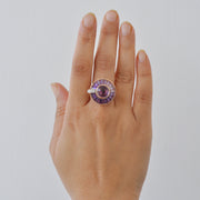 On-hand shot demonstrating the ring in motion, highlighting the sparkle of the rotating gemstones.