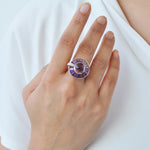 A model’s hand featuring the amethyst and gold ring,