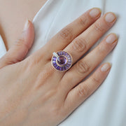 A model wearing the 14K rose gold amethyst and diamond ring on her middle finger, showing its scale.
