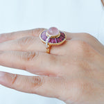 Close-up of the rotating ring being worn, showing how the rich pink colors catch the light.
