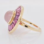 Angle view showing the raised central rose quartz cabochon and the depth of the 14K gold setting.