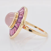 Angle view showing the raised central rose quartz cabochon and the depth of the 14K gold setting.