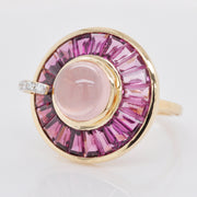 Macro shot of the central bezel-set rose quartz cabochon.
