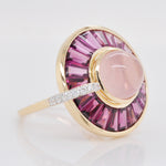 Side profile of the gold ring highlighting the channel setting of rhodolite baguettes and diamond detail.