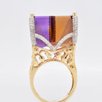 A three-quarter view showing the side profile and depth of the carved ametrine Taj Mahal ring.