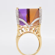 A three-quarter view showing the side profile and depth of the carved ametrine Taj Mahal ring.