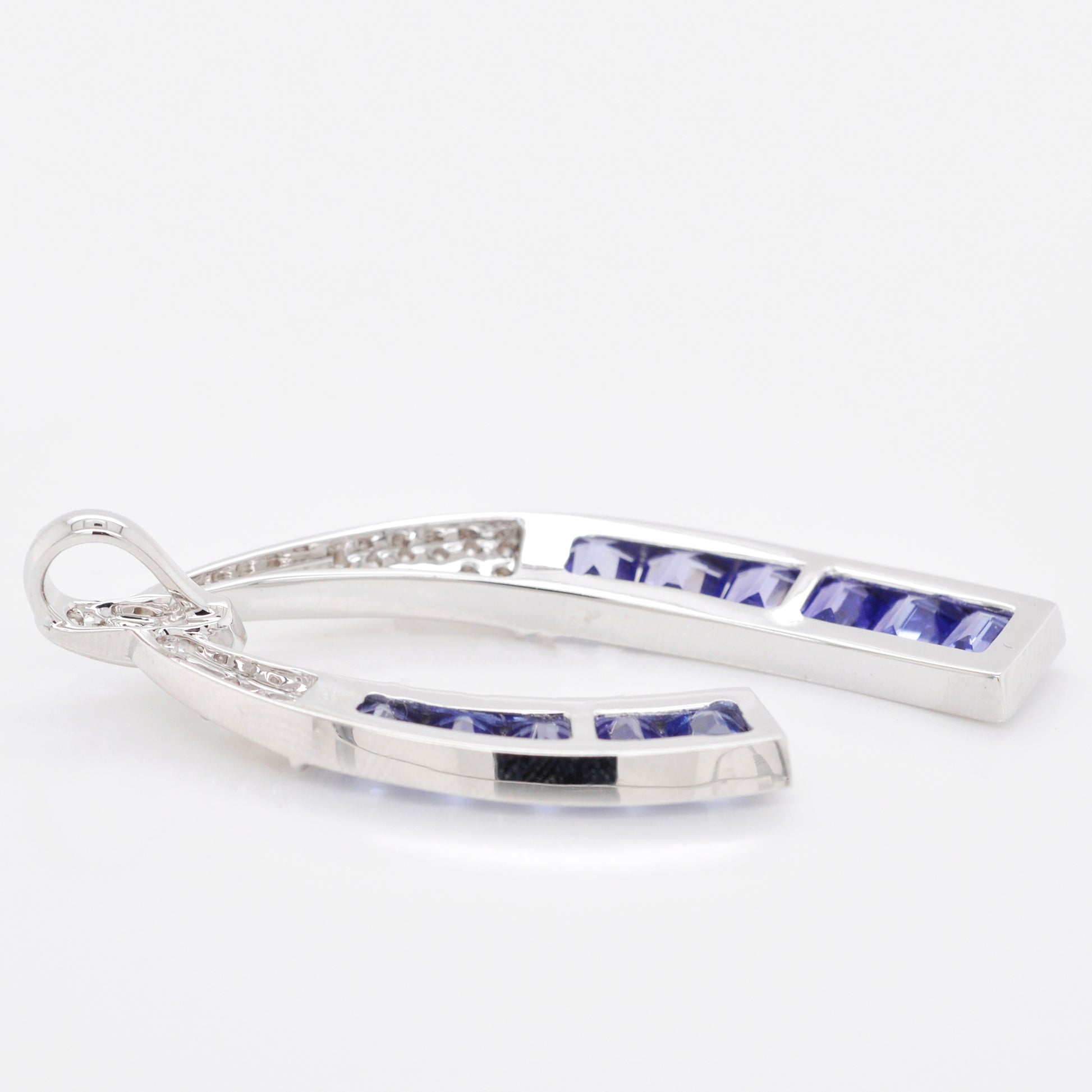 Gemstone pendant with tanzanite and baguette diamond horseshoe design