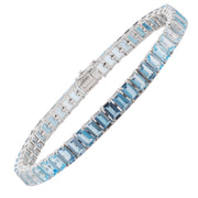 Octagon-cut blue topaz tennis bracelet in 14k white gold on a clean white background.