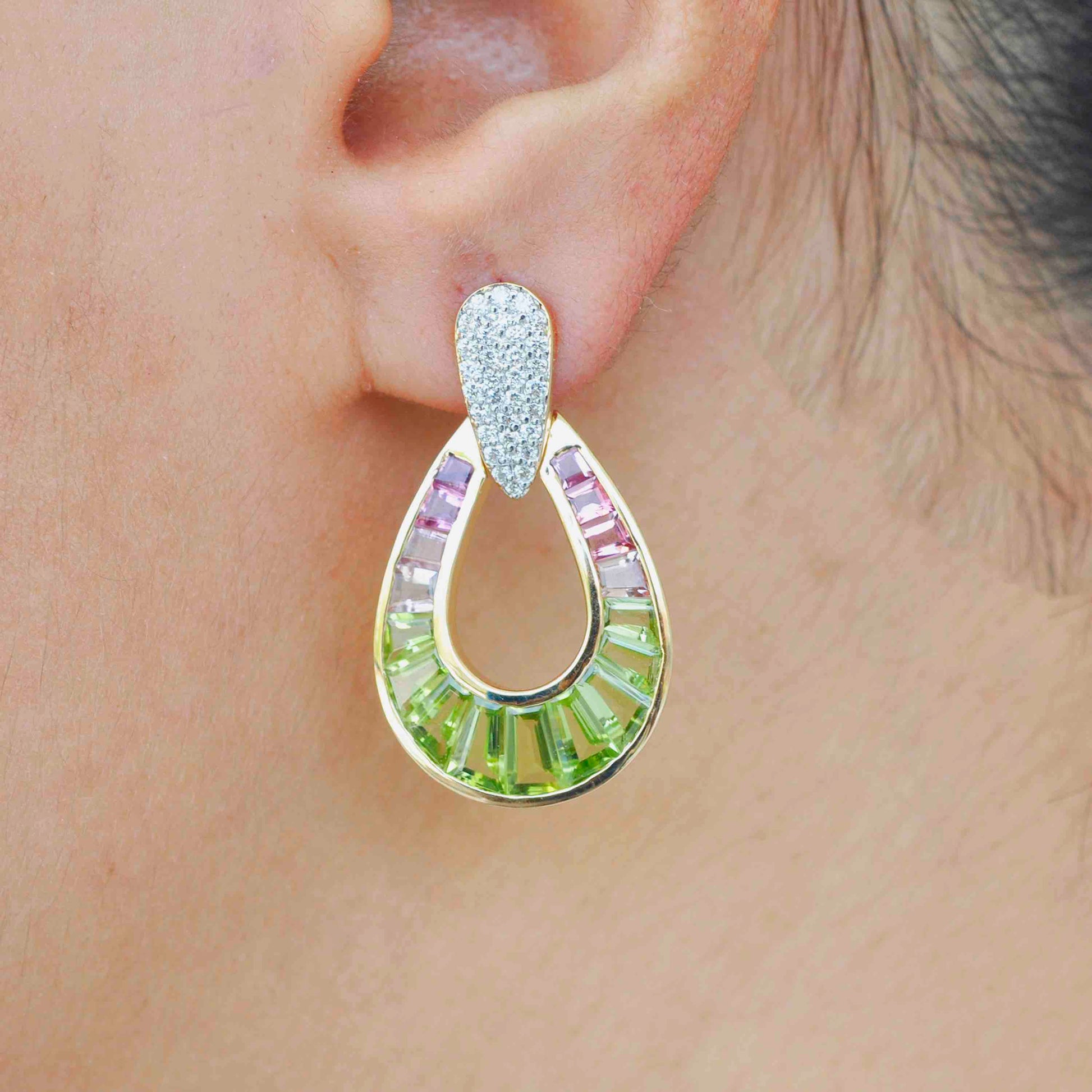 Handcrafted dangle earrings adorned with pink tourmaline, peridot, and diamonds.